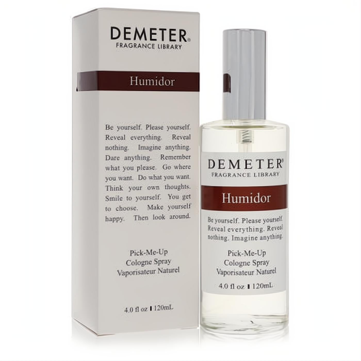 Demeter Humidor 4 oz women's cologne spray. Elegant clear glass bottle, sleek silver cap, and matching white box with brown accents.