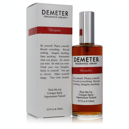 Demeter Mesquite 4 oz unisex cologne spray: clear glass bottle with warm amber liquid, silver cap, beside its crisp white and red box.