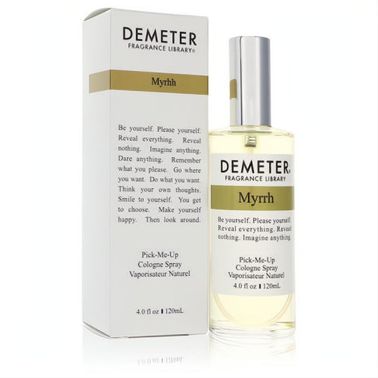 Demeter Myrrh 4 oz unisex cologne spray. Sleek clear glass bottle with silver cap and light amber liquid, beside its elegant white and gold box.