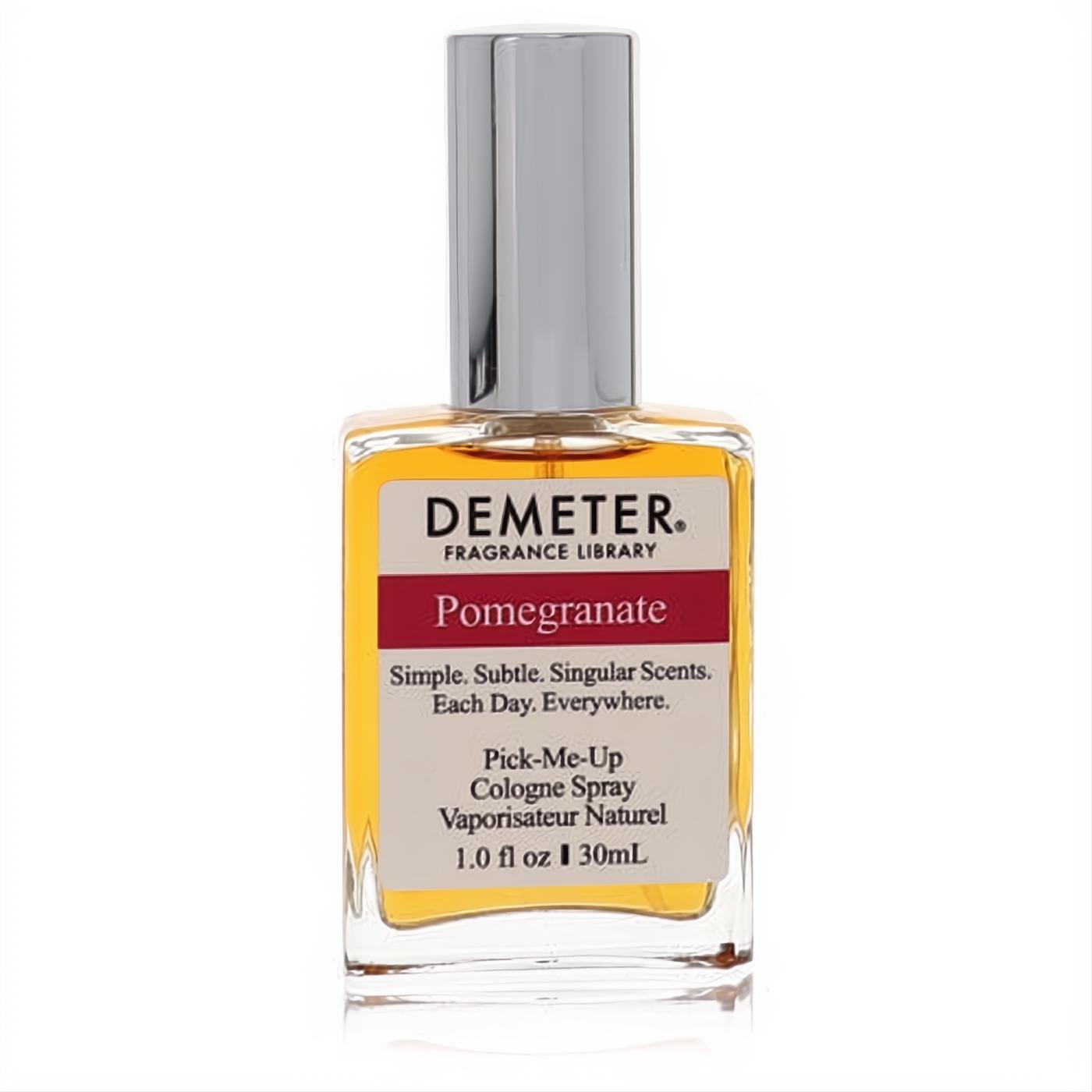 Demeter Pomegranate 1 oz cologne spray: a sleek clear glass bottle with golden liquid, silver cap, and a bold red label.