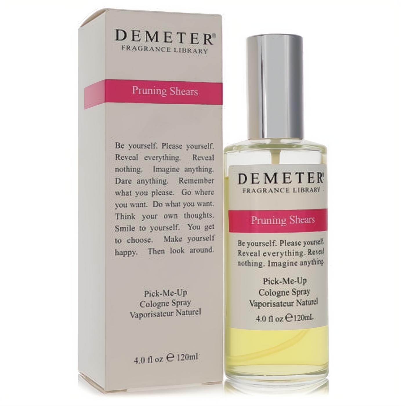 Demeter Pruning Shears 4 oz cologne spray. Elegant clear glass bottle with silver cap, vibrant yellow liquid, and crisp white box with a bold pink stripe. Discover fresh garden scents.