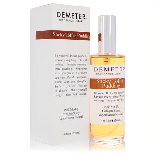 Demeter Sticky Toffee Pudding 4 oz cologne spray. Clear glass bottle with amber liquid, white cap, and matching white box. Experience this sweet gourmand fragrance.