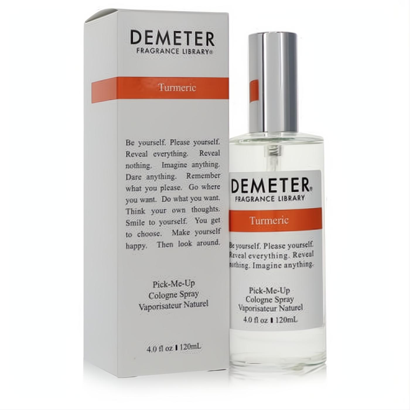 Demeter Turmeric 4 oz unisex cologne spray in a sleek clear bottle with silver cap, alongside its elegant white box featuring bold orange branding.