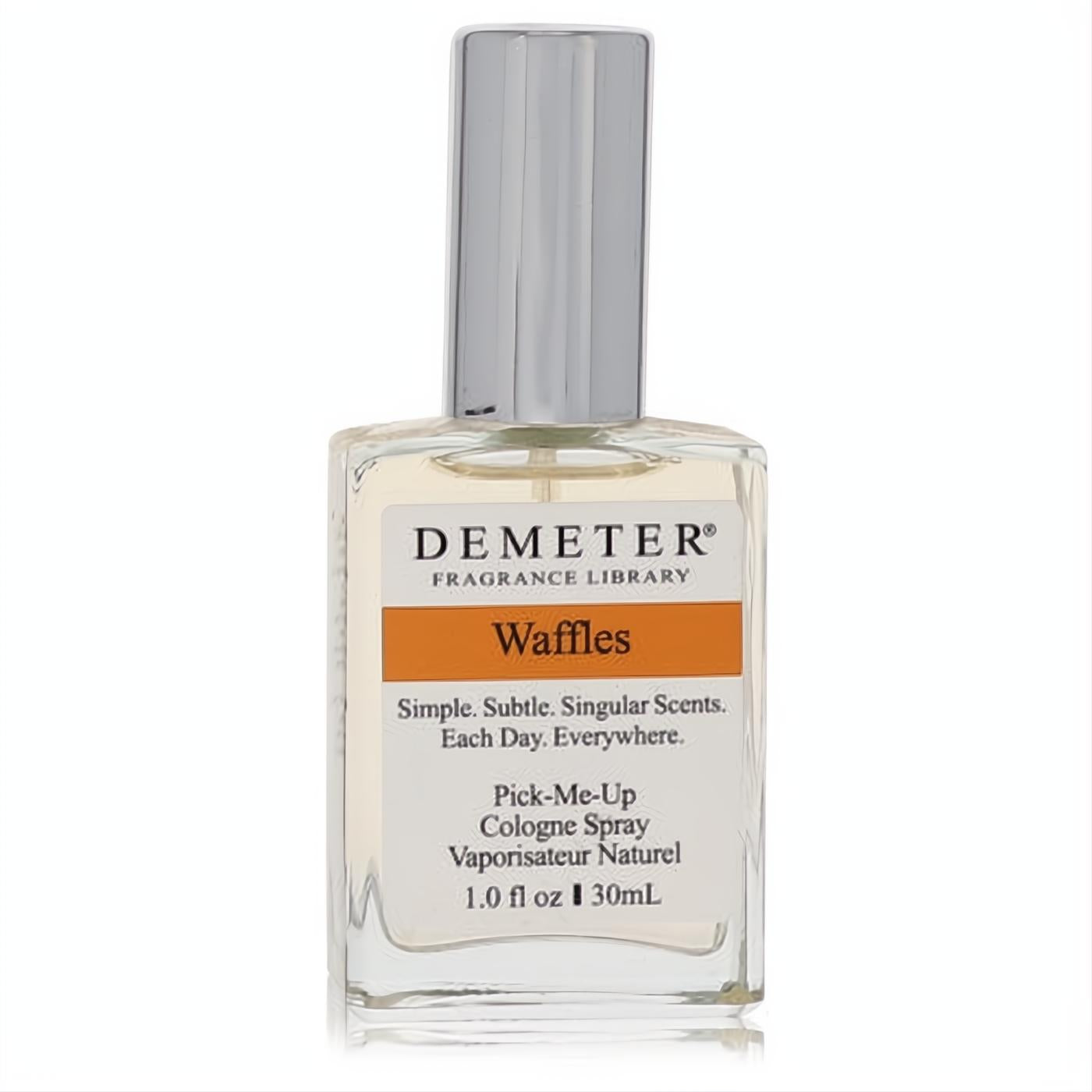 Indulge in Demeter Waffles 1 oz cologne spray. Clear glass bottle, sleek silver cap, and vibrant orange 'Waffles' label.