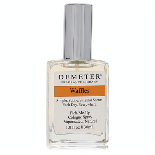 Indulge in Demeter Waffles 1 oz cologne spray. Clear glass bottle, sleek silver cap, and vibrant orange 'Waffles' label.