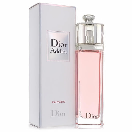 Dior Addict Eau Fraiche women's perfume. Clear glass bottle with sparkling light pink fragrance, alongside its elegant white box.