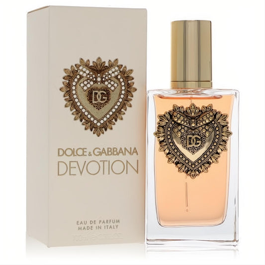Luxurious Dolce & Gabbana Devotion 3.3 oz EDP spray bottle with a gold sacred heart emblem, beside its elegant cream box.