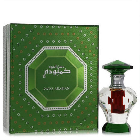 Swiss Arabian Dood Cambodi attar: small faceted clear glass bottle with rich red liquid, green gem-like cap, and elegant green box.