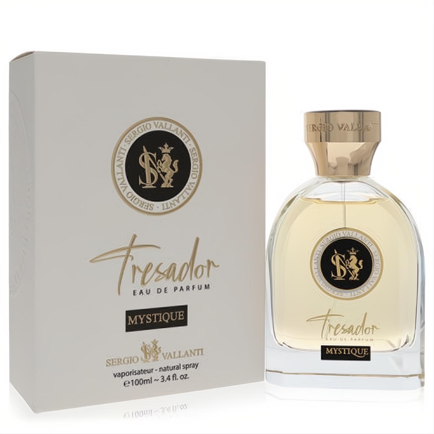 Experience Dumont Tresador Mystique unisex 3.4 oz EDP. Elegant clear glass bottle with gold cap and accents, beside its luxurious white box.