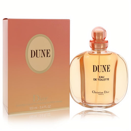 Experience Dune by Christian Dior 3.4 oz EDT. Golden fragrance in an elegant clear bottle, paired with a warm peach gradient box.