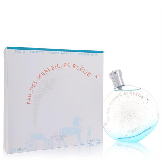 Captivating Hermes Eau des Merveilles Bleue 3.4 oz women's EDT. Features a round blue-tinted bottle with star design and elegant white box.