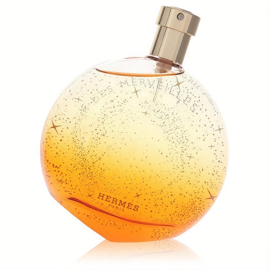 Enchanting Hermes Elixir Des Merveilles 3.3 oz women's EDP. Sparkling amber-gold spherical glass bottle with a chic gold cap.