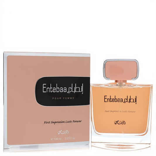 Luxurious Rasasi Entebaa 3.33 oz women's EDP. Amber liquid in a clear glass bottle with a peach-gold cap, presented with its matching elegant box.
