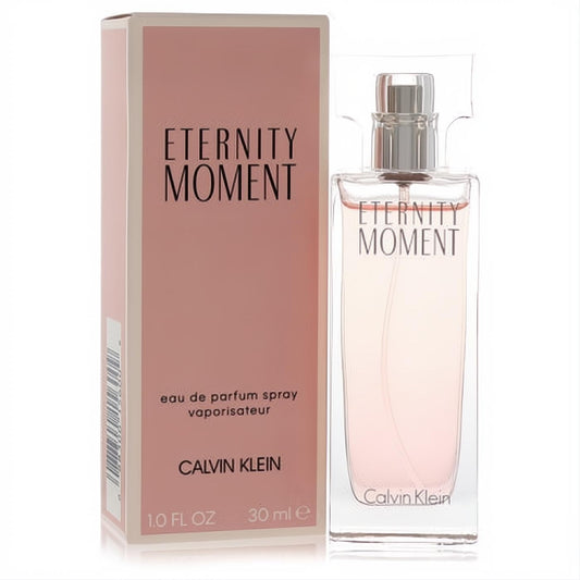 Calvin Klein Eternity Moment 1 oz EDP spray. Elegant clear glass bottle with pale pink fragrance, silver cap, and soft pink box.