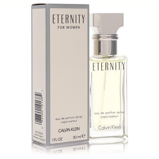 Elegant Eternity by Calvin Klein 1 oz EDP spray. Clear glass bottle with light yellow fragrance, sleek silver cap, beside its chic beige box.