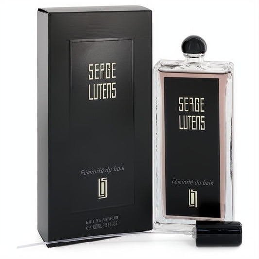 Elegant Serge Lutens Féminité du bois 3.3 oz EDP. Clear glass bottle with pink liquid, gold lettering, and sleek black box.