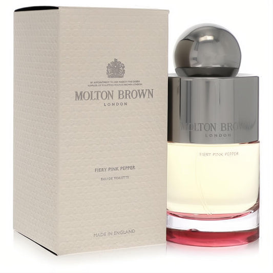 Molton Brown Fiery Pink Pepper EDT spray. Elegant clear glass bottle with a vibrant red base, sleek silver cap, and textured beige box.