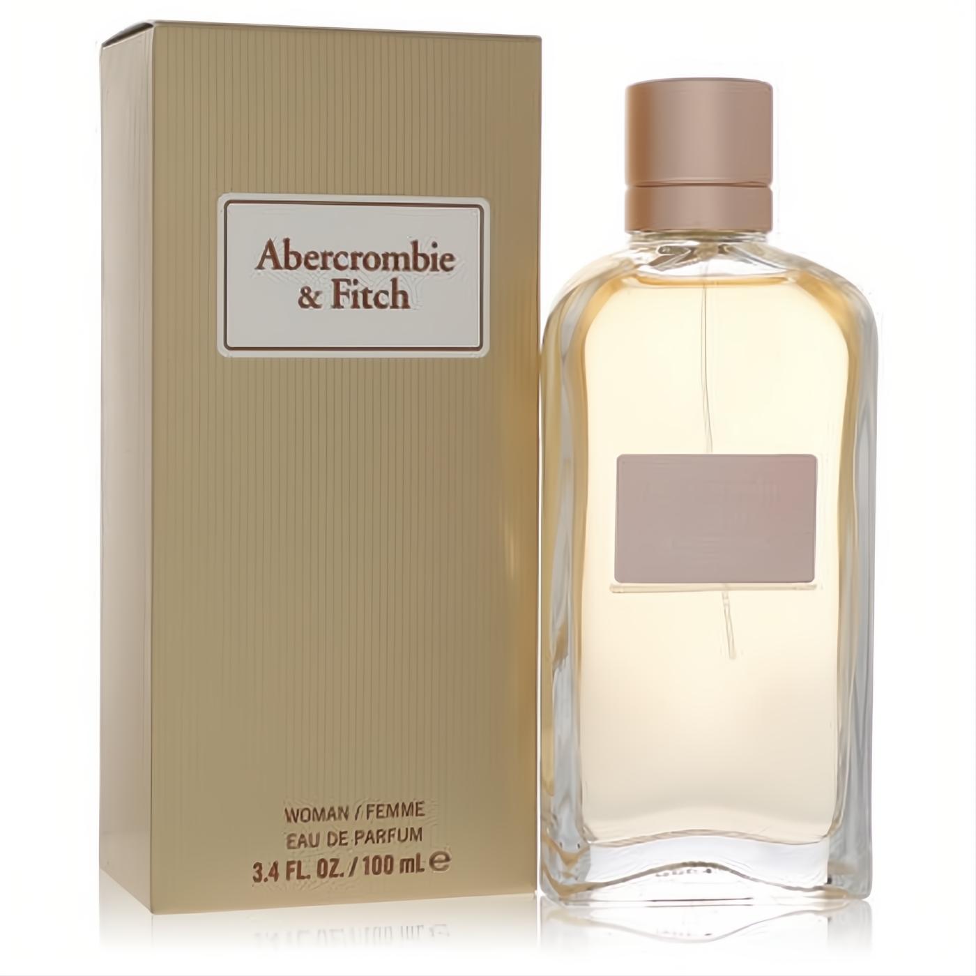 Abercrombie & Fitch First Instinct Sheer 3.4 oz Eau De Parfum. Sleek clear glass bottle, rose gold cap, and matching golden box.