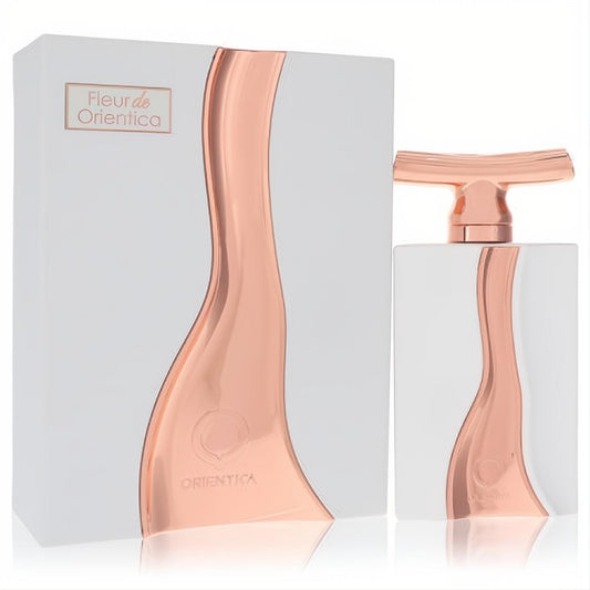 Stunning Fleur De Orientica EDP. White bottle with a captivating rose gold metallic wave and T-shaped cap, next to its elegant matching box.
