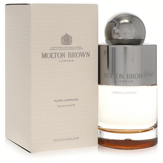 Molton Brown Flora Luminare 3.3 oz unisex EDT spray. Luxurious cream box and elegant glass bottle with a gleaming silver cap.