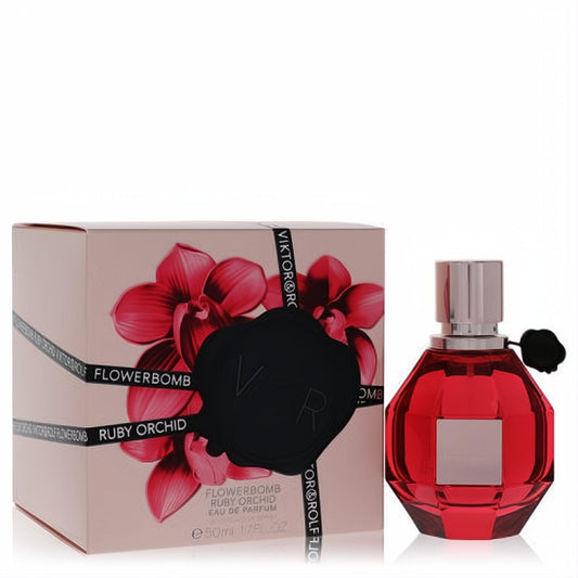 Flowerbomb Ruby Orchid 1.7 oz: Ruby red faceted bottle, silver cap, black charm, and elegant pink box with red orchids.