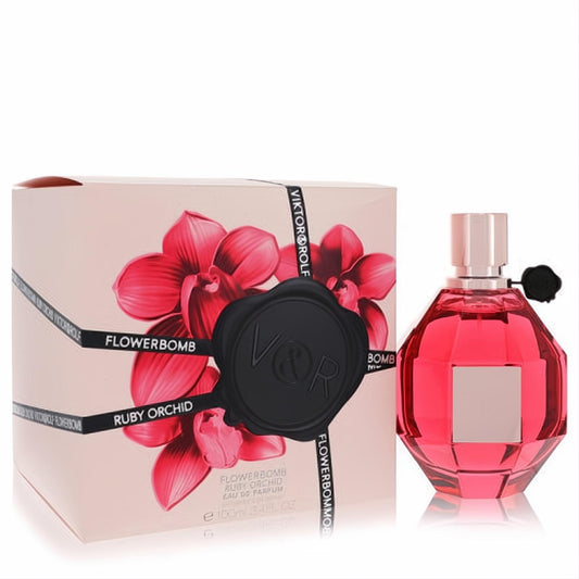 Luxurious Viktor & Rolf Flowerbomb Ruby Orchid 3.4 oz EDP. Ruby red faceted bottle with black flower, beside its pink orchid box.