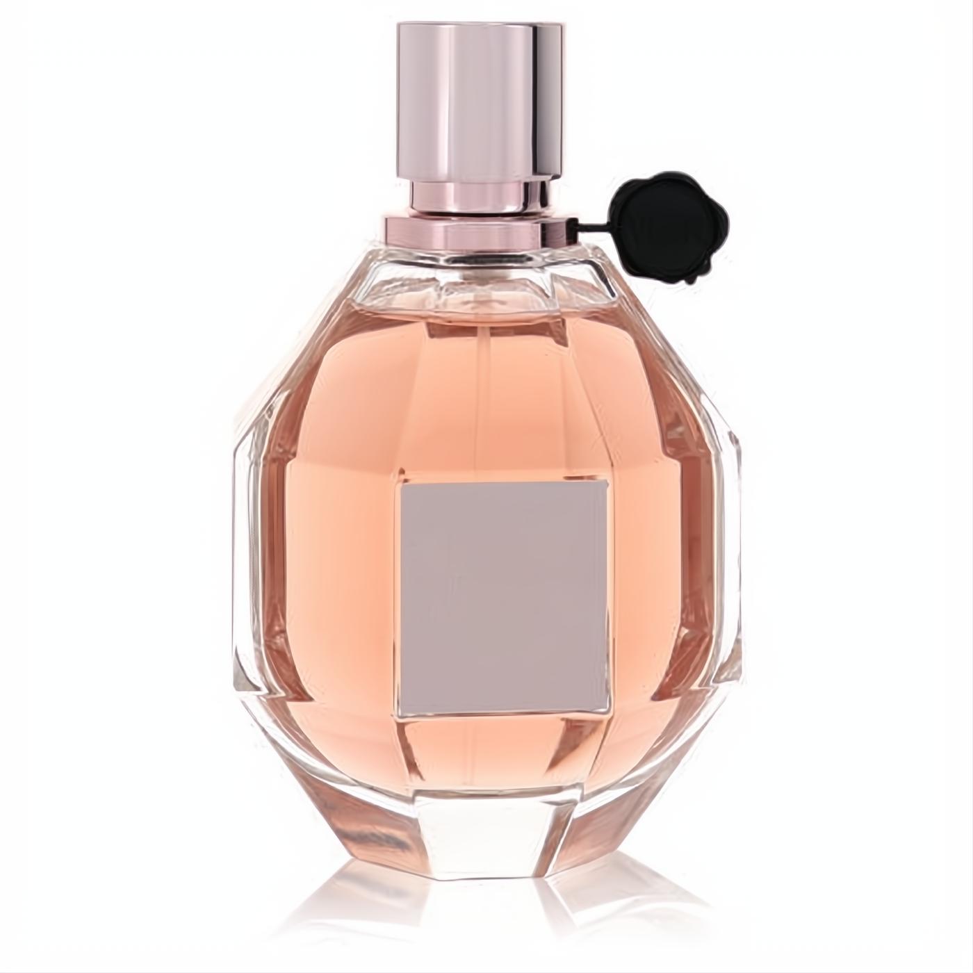 Elegant Flowerbomb tester perfume: faceted glass bottle with soft pink fragrance, rose gold cap, and signature black flower charm.