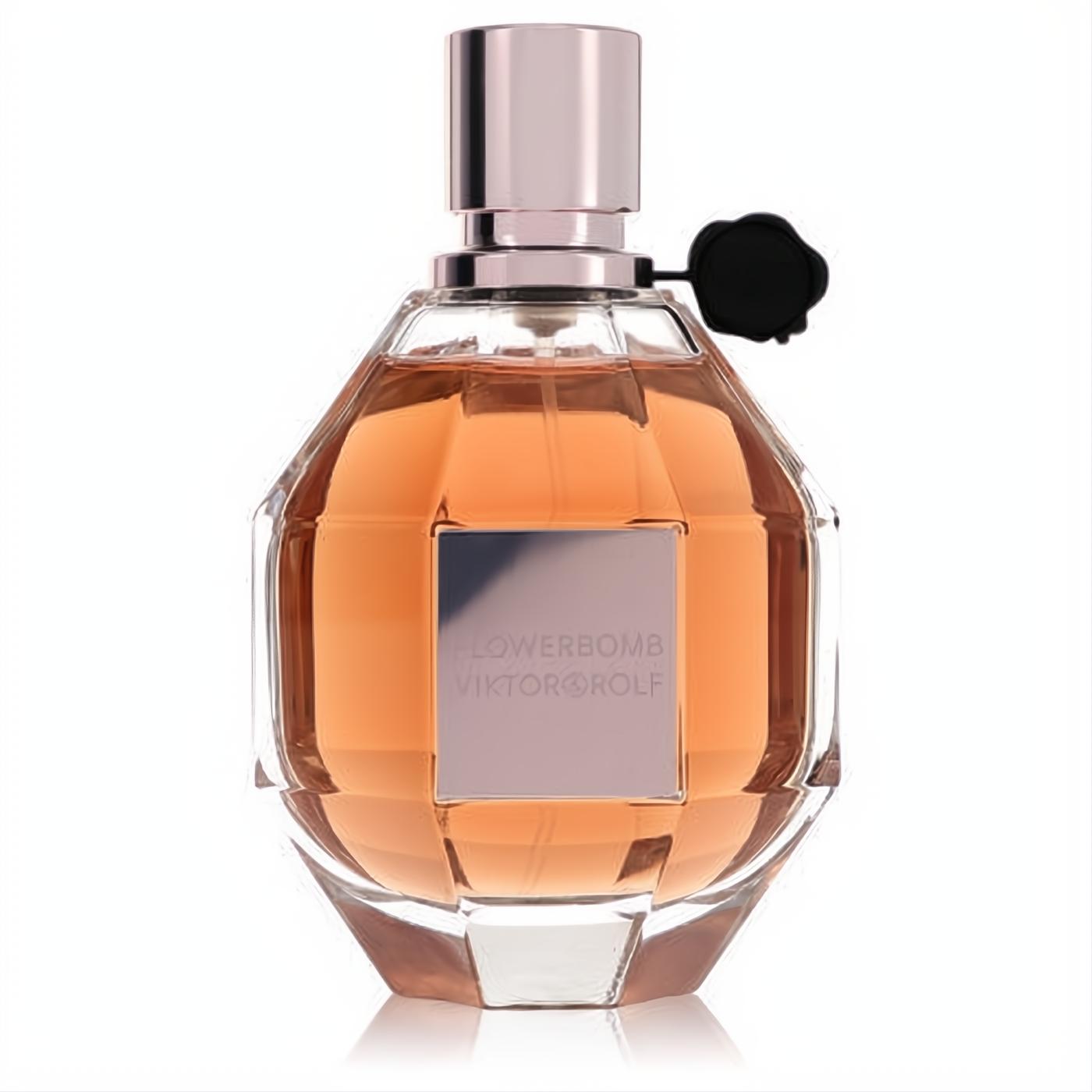 Viktor & Rolf Flowerbomb perfume. Elegant faceted glass bottle with warm peach liquid, rose gold cap, and black flower seal.