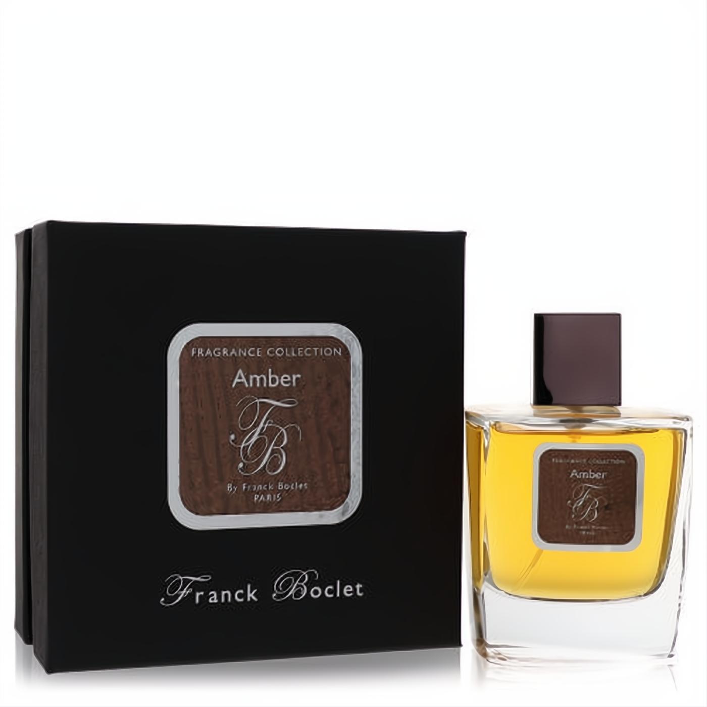 Elegant Franck Boclet Amber unisex EDP spray. Clear glass bottle with golden liquid, dark cap, and luxurious black box with "FB" logo.