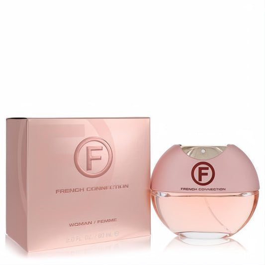 Discover French Connection Woman 2 oz EDT. Chic pink box and elegant round bottle with "F" logo, showcasing a captivating peach-pink fragrance.