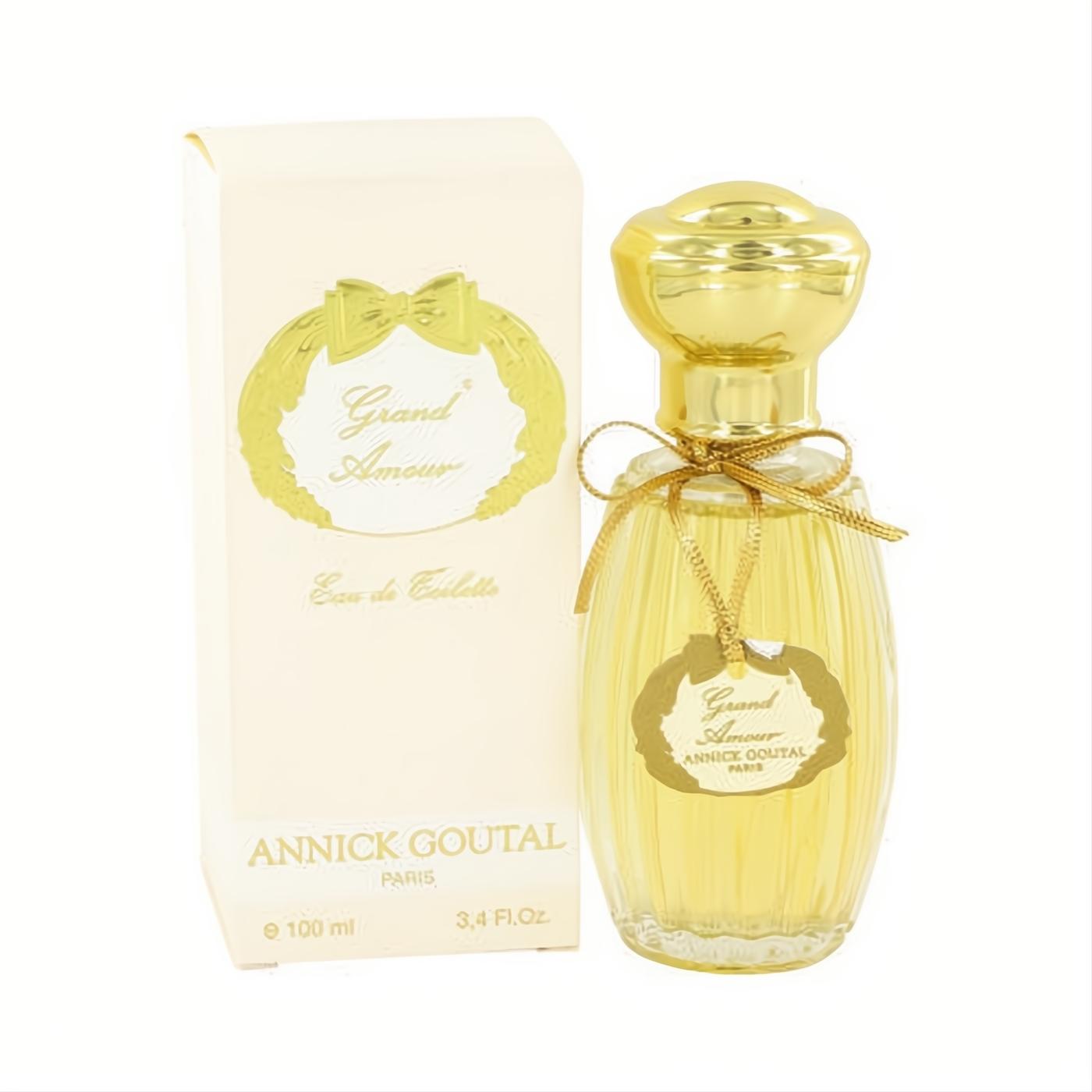 Grand Amour by Annick Goutal 3.4 oz Eau de Toilette. Elegant ribbed glass bottle with golden liquid, gold cap, ribbon, and cream box.