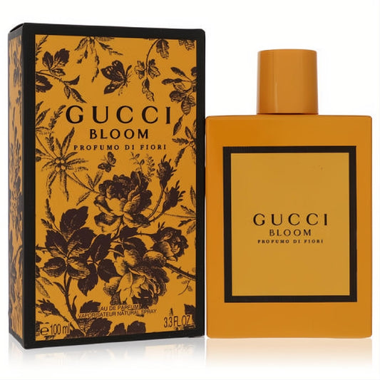 Experience Gucci Bloom Profumo Di Fiori 3.3 oz EDP. Vibrant amber yellow bottle and box featuring a sophisticated black floral and butterfly design.