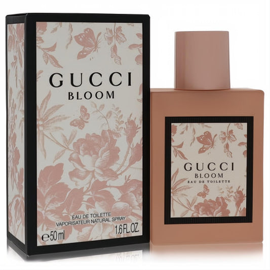 Gucci Bloom Eau De Toilette 1.6 oz. Elegant blush pink matte bottle with a delicate floral design, next to its black box.