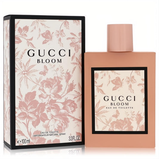 Gucci Bloom 3.3 oz EDT spray. Elegant peach bottle with a delicate pink floral and butterfly design, presented with its matching box.