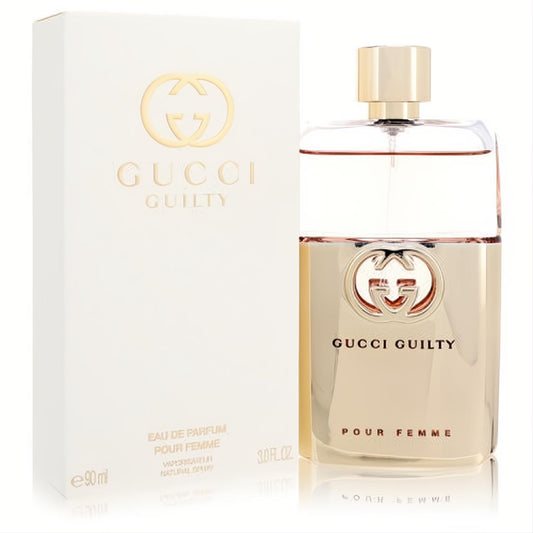 Gucci Guilty Pour Femme 3 oz EDP spray in a sleek gold and clear bottle with iconic GG logo, beside its elegant white box.