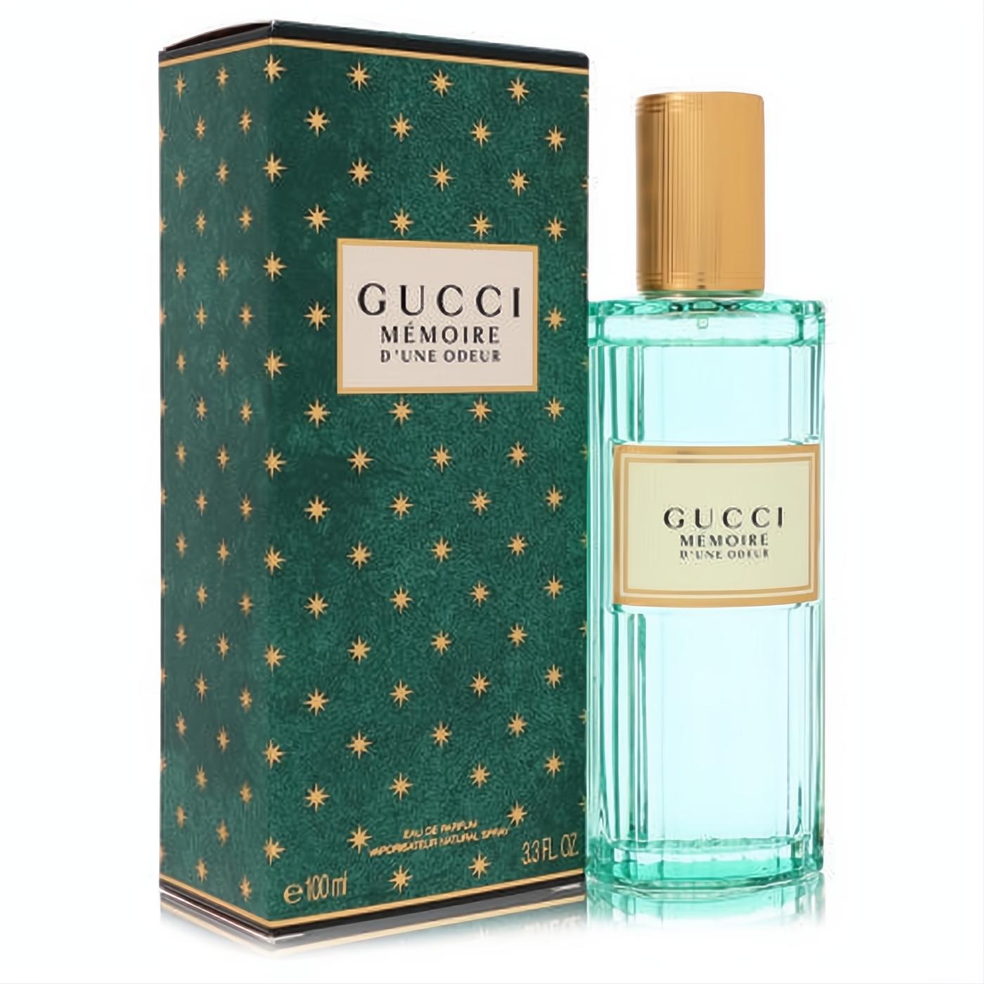 Gucci Memoire D'une Odeur 3.3 oz unisex EDP. Elegant ribbed teal glass bottle with gold cap and iconic dark green star box.