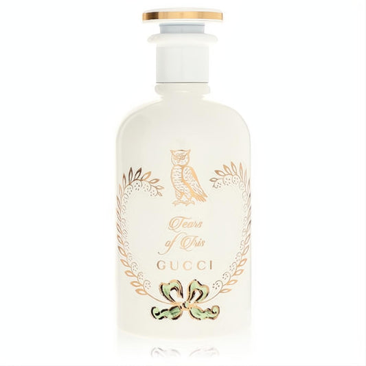 Exquisite Gucci Tears of Iris perfume bottle. Opaque white glass, adorned with a gold owl, 'Tears of Iris' script, and a delicate green bow. Gold cap.