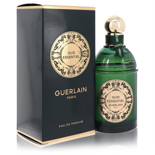 Guerlain Oud Essentiel Eau De Parfum. Elegant dark green fluted glass bottle with gold cap and matching box.