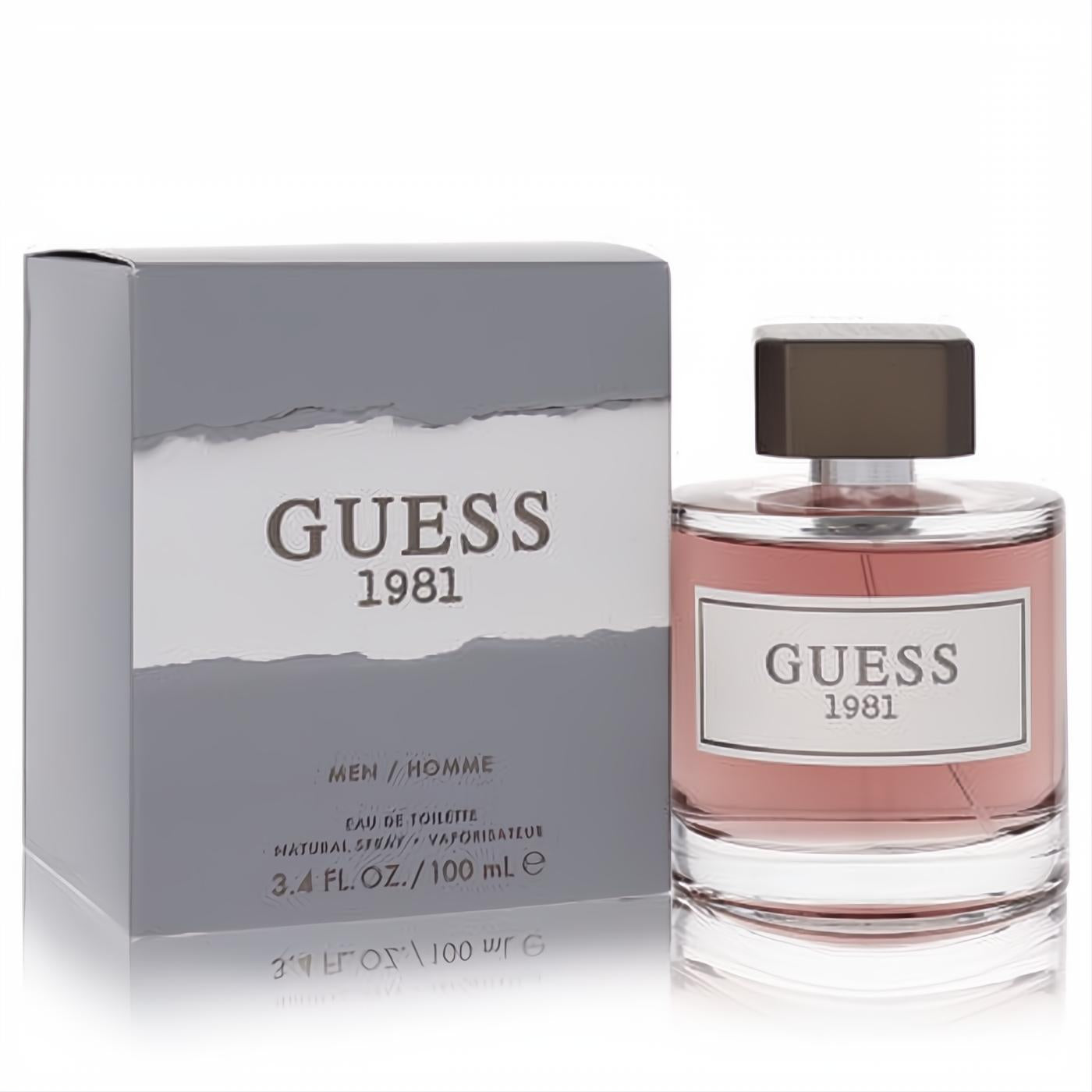 Guess 1981 Men's Eau De Toilette 3.4 oz. Sleek glass bottle with reddish fragrance, brown cap, and modern gray packaging.