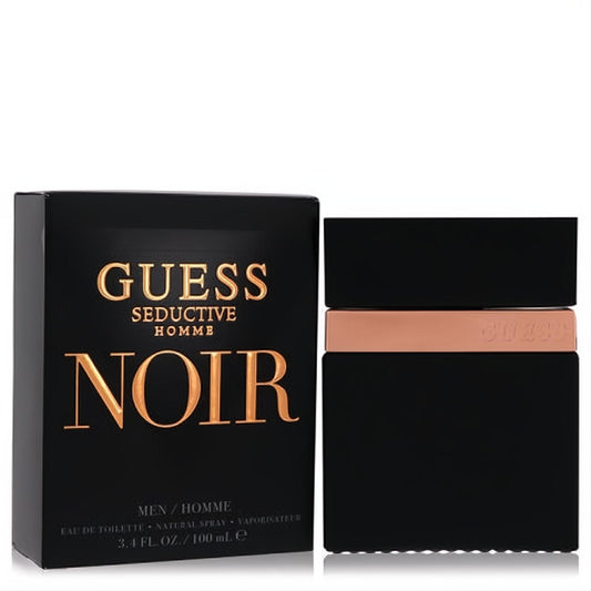 Guess Seductive Homme Noir 3.4 oz EDT. Sleek black bottle with bronze Guess band, next to its elegant black and gold box.