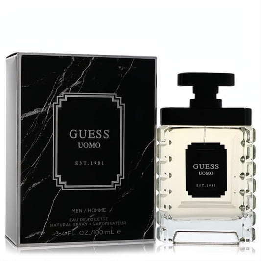 Guess Uomo 3.4 oz Eau De Toilette. Modern clear glass bottle with textured design, paired with a luxurious black marble box.