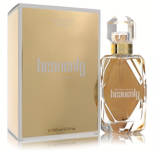Victoria's Secret Heavenly 3.4 oz EDP. Luxurious faceted glass bottle with a sparkling crystal cap, next to its radiant gold box.