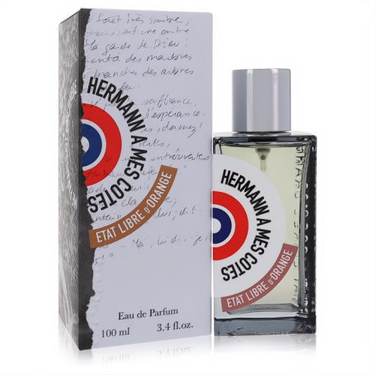 Sophisticated Etat Libre D'Orange Hermann A Mes Cotes 3.4 oz unisex EDP. Clear glass bottle, silver cap, iconic red/blue logo. White box with elegant script.