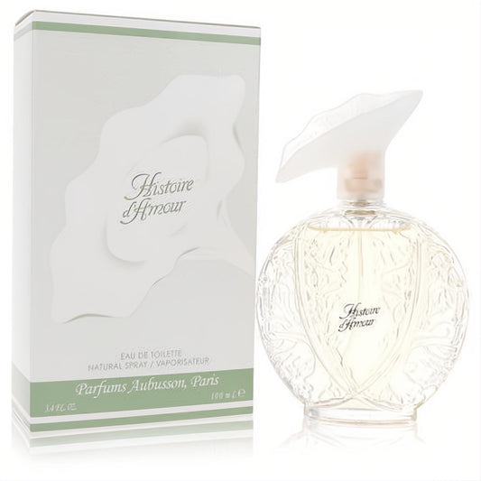 Histoire D'Amour Aubusson 3.4 oz EDT. Elegant clear floral bottle with a unique leaf cap, next to its white and green box.