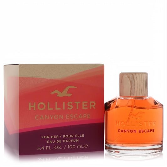 Hollister Canyon Escape 3.4 oz EDP. Vibrant orange perfume bottle with a natural wood cap and matching sunset-gradient box.