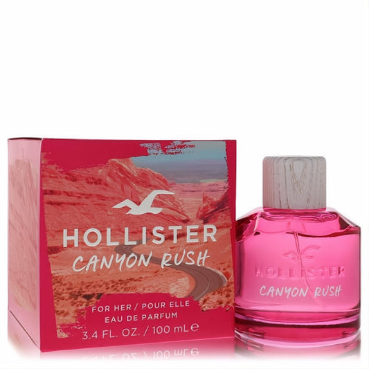Unleash adventure with Hollister Canyon Rush 3.4 oz EDP. Vibrant pink bottle, wood-grain cap, and stunning desert box.