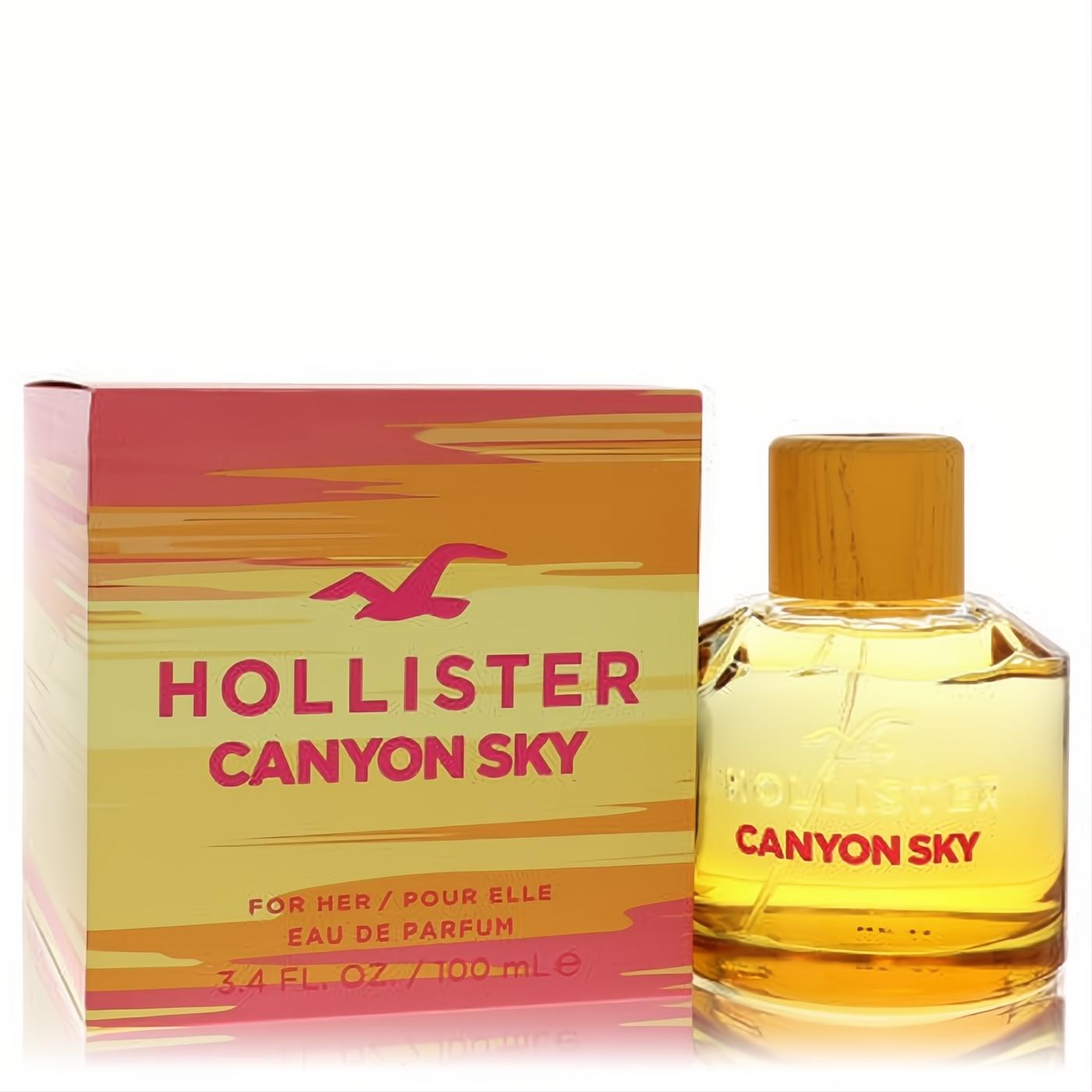 Captivating Hollister Canyon Sky 3.4 oz EDP. Golden liquid in a clear, faceted bottle, alongside its vibrant sunset-striped box.