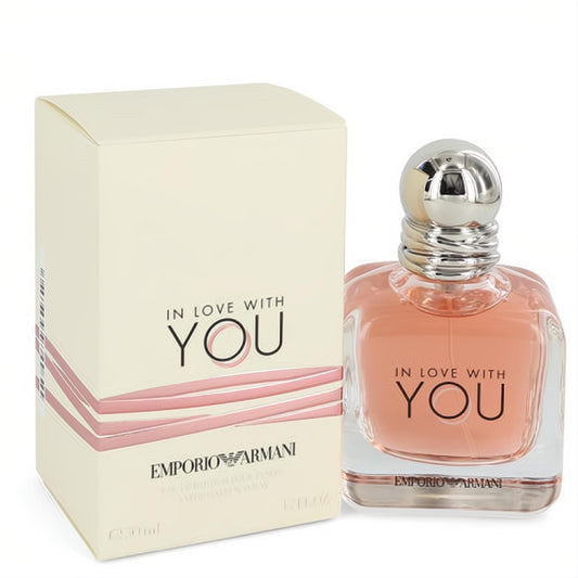 Elegant Giorgio Armani In Love With You 1.7 oz EDP. Clear glass bottle with peach fragrance, silver cap, and matching cream box.