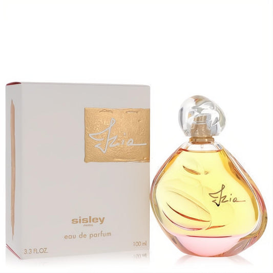 Sisley Izia Eau de Parfum 3.4 oz, a stunning gold-to-pink gradient glass bottle with a clear sculpted cap, next to its chic white and gold box.