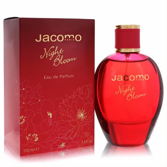 Jacomo Night Bloom 3.4 oz Eau de Parfum. A vibrant, rounded red glass bottle with a gold-banded cap, beside its elegant floral red box.